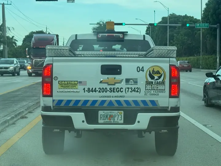Sun Eagle contractor pickup displaying phones 305-713-5668 and 844-200-7342 with licenses CGC1529983 and EC13006420