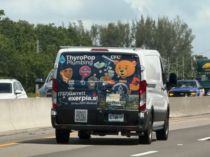 Colorfully illustrated ThyroPop Plumbing van displaying the vanity phone number 737-GARRETT