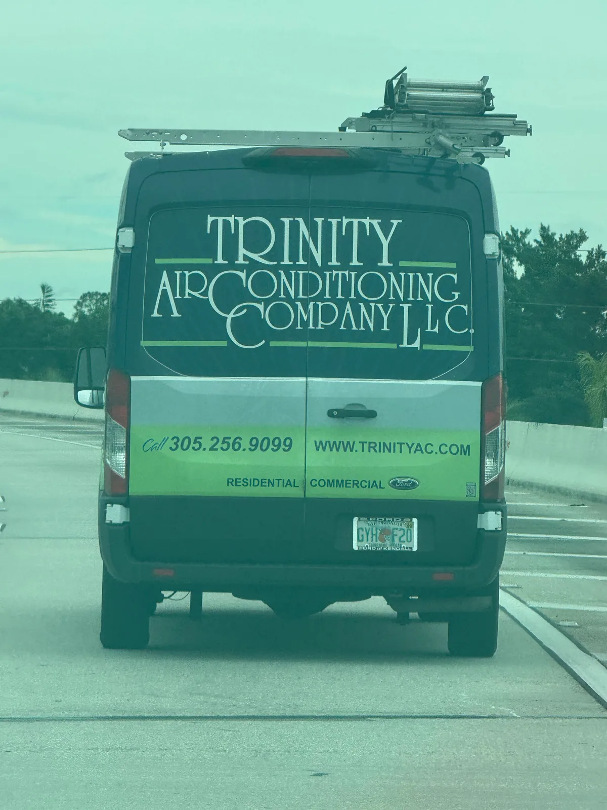 Trinity Air Conditioning Company LLC work vehicle displaying its business name and contact information